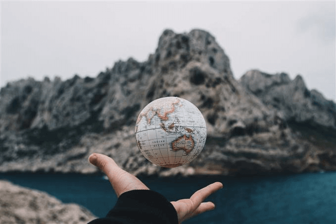 Small globe against a cliffside backdrop